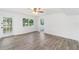 Bright bedroom featuring wood-look floors and windows allowing for ample natural light at 23475 Harper Ave, Port Charlotte, FL 33980