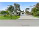 Charming single-story home with a well-maintained lawn and long driveway at 23475 Harper Ave, Port Charlotte, FL 33980
