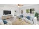 Bright living room featuring wood flooring, neutral walls, ceiling fan, and stylish decor at 23475 Harper Ave, Port Charlotte, FL 33980