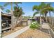 This backyard has a utility shed, a tower with access to the pool, a screen enclosed porch, and dining area at 23475 Harper Ave, Port Charlotte, FL 33980