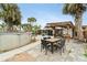 Open backyard with a patio, above-ground pool, wooden pergola, and mature landscaping for outdoor enjoyment at 23475 Harper Ave, Port Charlotte, FL 33980