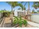 View of backyard featuring a utility shed, small tower, various plants, and a stone walkway at 23475 Harper Ave, Port Charlotte, FL 33980