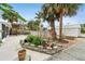 Spacious backyard featuring a patio, lush landscaping, mature palm trees, and an above-ground pool at 23475 Harper Ave, Port Charlotte, FL 33980