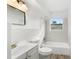 Bright bathroom with new vanity, sink, toilet, bathtub, updated fixtures, and stylish tiling at 23475 Harper Ave, Port Charlotte, FL 33980
