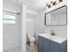 Modern bathroom features a vanity, tiled shower, stylish fixtures, and great lighting at 23475 Harper Ave, Port Charlotte, FL 33980