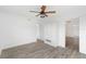 Bright bedroom featuring wood floors, built-in storage, and a window with backyard view at 23475 Harper Ave, Port Charlotte, FL 33980