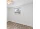 Cozy bedroom with wood-look flooring, a window, and neutral decor at 23475 Harper Ave, Port Charlotte, FL 33980