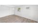 Bedroom featuring updated flooring, ample closet space, and natural light at 23475 Harper Ave, Port Charlotte, FL 33980