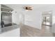 Open-concept kitchen with stainless appliances, granite countertops, and a decorative ceiling fan at 23475 Harper Ave, Port Charlotte, FL 33980