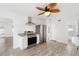 Bright, white kitchen features stainless steel appliances, granite counters, and a modern ceiling fan at 23475 Harper Ave, Port Charlotte, FL 33980