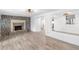 Spacious living room with a stone fireplace and wood-look flooring, great for entertaining at 23475 Harper Ave, Port Charlotte, FL 33980