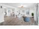 Bright staged living room featuring wood floors, white walls and trim, and lots of natural light at 23475 Harper Ave, Port Charlotte, FL 33980