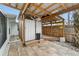 Covered outdoor shower with a wooden deck, privacy walls, and convenient access from the patio at 23475 Harper Ave, Port Charlotte, FL 33980