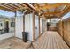 Covered outdoor shower area featuring a wooden deck, shower fixtures, and adjacent patio space at 23475 Harper Ave, Port Charlotte, FL 33980