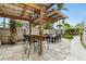 Outdoor patio with a covered bar and dining area perfect for entertaining in a private backyard at 23475 Harper Ave, Port Charlotte, FL 33980