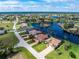 Aerial view of home, landscaping, and lake in community close to the ocean at 24362 Peppercorn Rd, Punta Gorda, FL 33955