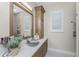 Bathroom vanity features wood cabinets, white countertops, and a vessel sink with a waterfall faucet at 24362 Peppercorn Rd, Punta Gorda, FL 33955
