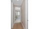 Hallway view into the bathroom features a soaking tub and bright window with plantation shutters at 24362 Peppercorn Rd, Punta Gorda, FL 33955