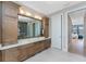 Bathroom features double vanity, wood cabinets, and views of the waterfront through to the bedroom at 24362 Peppercorn Rd, Punta Gorda, FL 33955