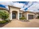 Beautifully landscaped home featuring a double-door entryway and neutral color scheme at 24362 Peppercorn Rd, Punta Gorda, FL 33955