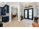 Welcoming foyer with double doors, chandelier, and view of the office featuring a custom bar area at 24362 Peppercorn Rd, Punta Gorda, FL 33955