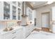 Elegant kitchen featuring white cabinets, quartz countertops, and modern appliances at 24362 Peppercorn Rd, Punta Gorda, FL 33955