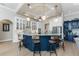 Stylish kitchen with a central island, breakfast bar seating, custom cabinetry, and modern stainless steel appliances at 24362 Peppercorn Rd, Punta Gorda, FL 33955