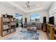 Inviting living room with water view, complemented by area rug, decorative pillows, ceiling fan and natural lighting at 24362 Peppercorn Rd, Punta Gorda, FL 33955