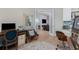 Well-lit office with wood floors offering views of a sitting area, the kitchen and a Gathering room at 24362 Peppercorn Rd, Punta Gorda, FL 33955