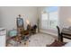 Charming office with wood floors, area rug, shuttered window, and artist's easel setup at 24362 Peppercorn Rd, Punta Gorda, FL 33955