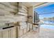 Outdoor kitchen with grill overlooking a lake at 24362 Peppercorn Rd, Punta Gorda, FL 33955
