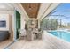 Cozy patio featuring an outdoor kitchen, seating area, and screened-in pool at 24362 Peppercorn Rd, Punta Gorda, FL 33955