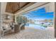 Inviting outdoor living space with a covered patio, pool, and lake view at 24362 Peppercorn Rd, Punta Gorda, FL 33955