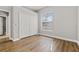 Bedroom with wood floors, a window with blinds, and a closet with double doors at 2621 Coldwater Ln, North Port, FL 34286