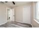 Comfortable bedroom with gray floors, two closets, a ceiling fan, and access to the bathroom at 3213 Normandy Dr, Port Charlotte, FL 33952