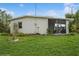 Exterior view of the back of the house with a screened in porch at 3213 Normandy Dr, Port Charlotte, FL 33952