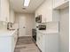 Modern kitchen featuring white cabinets, quartz countertops, stainless steel appliances and plank flooring at 3213 Normandy Dr, Port Charlotte, FL 33952