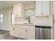 Bright kitchen featuring sleek stainless steel appliances, white cabinetry, and a stainless steel dishwasher at 3213 Normandy Dr, Port Charlotte, FL 33952