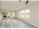Inviting living room featuring gray floors, an exposed brick fireplace, and large windows at 3213 Normandy Dr, Port Charlotte, FL 33952