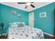 Charming bedroom featuring bright teal walls and a comfortable bed with a coastal theme at 341 Duxbury Ave, Port Charlotte, FL 33952