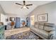 Bright living room featuring a vaulted ceiling, ceiling fan, and stylish furnishings at 3415 Knox Ter, Port Charlotte, FL 33948