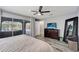 Bright main bedroom boasts sliding doors to the lanai, dark wood dresser and floors, and neutral decor at 3415 Knox Ter, Port Charlotte, FL 33948