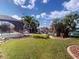 Expansive lawn leading to a waterway and boat dock, surrounded by tropical landscaping at 399 Bal Harbor Blvd, Punta Gorda, FL 33950
