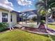 Back yard showcasing a screened lanai and refreshing pool, all encompassed by lush greenery at 399 Bal Harbor Blvd, Punta Gorda, FL 33950