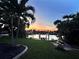 Picturesque backyard showcasing lush greenery, a waterfront view, and a tranquil setting with palm trees at 399 Bal Harbor Blvd, Punta Gorda, FL 33950