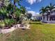 Beautiful backyard with tropical landscaping that enhances the home's curb appeal at 399 Bal Harbor Blvd, Punta Gorda, FL 33950