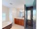 Bathroom with tile flooring, vanity with wood cabinets, and a marble shower at 399 Bal Harbor Blvd, Punta Gorda, FL 33950
