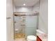 Updated bathroom boasts marble tiled shower, glass doors, and modern toilet at 399 Bal Harbor Blvd, Punta Gorda, FL 33950