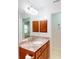 Bathroom featuring granite counters, wooden cabinets and sink with vanity mirror at 399 Bal Harbor Blvd, Punta Gorda, FL 33950