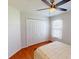 Bedroom featuring a ceiling fan, closet and hardwood floors at 399 Bal Harbor Blvd, Punta Gorda, FL 33950